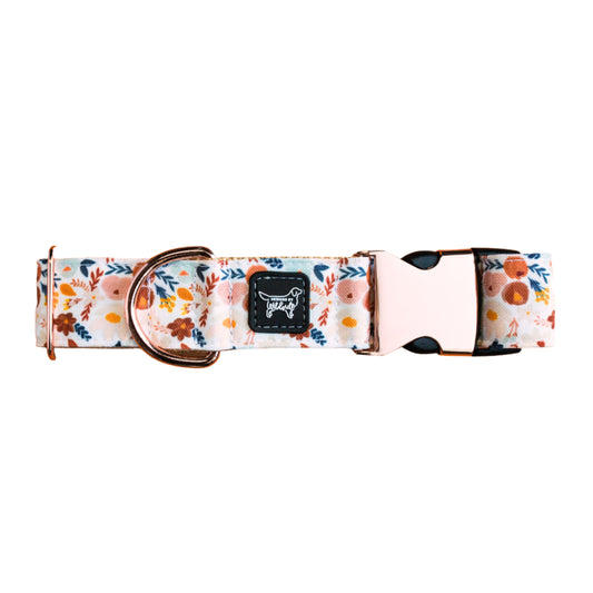 Floral patterned dog collar with a brand logo on a white background