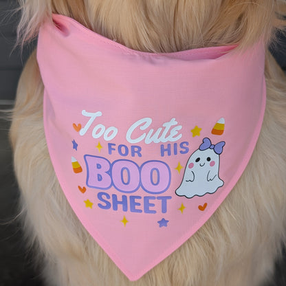 Dog wearing a pink bandana with text and a ghost graphic