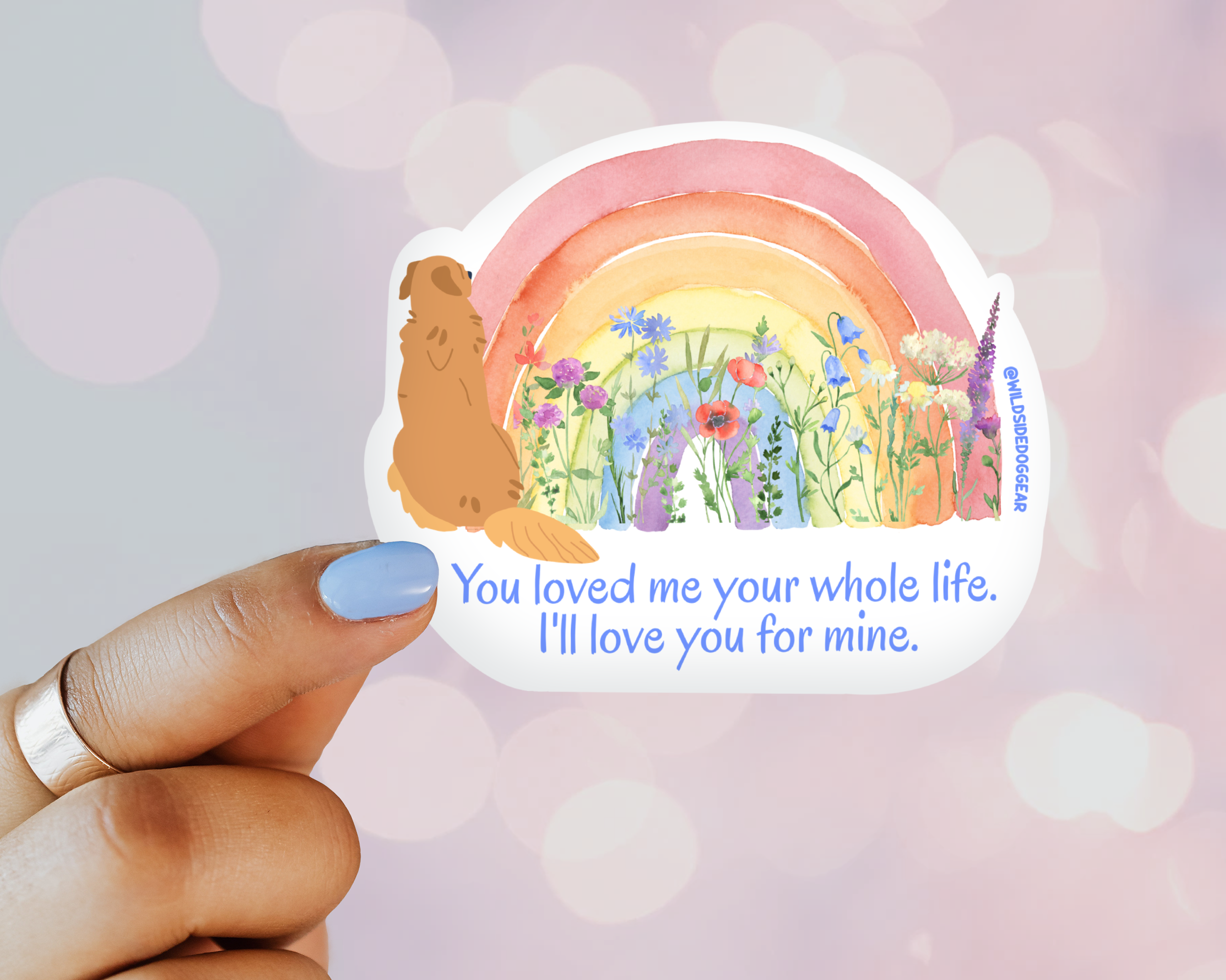 Sticker with a rainbow, flowers, and text held by a hand against a blurred background, golden retriever sticker, dog mom sticker, rainbow bridge, dog memorial gift