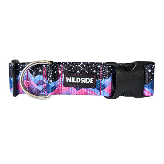 Dog collar featuring a vibrant watercolor-style mountain range in shades of pink and blue beneath a black night sky filled with white stars and constellations. Dog collar and 