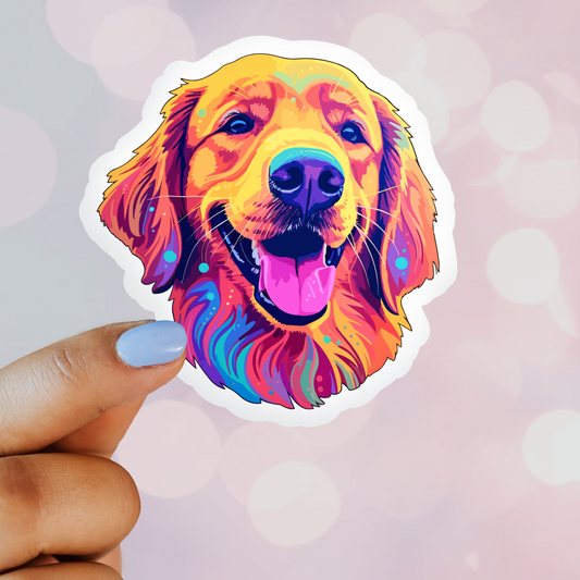 A colorful vinyl sticker of a smiling Golden Retriever surrounded by vibrant rainbow colors, held by a hand against a pink background with confetti.